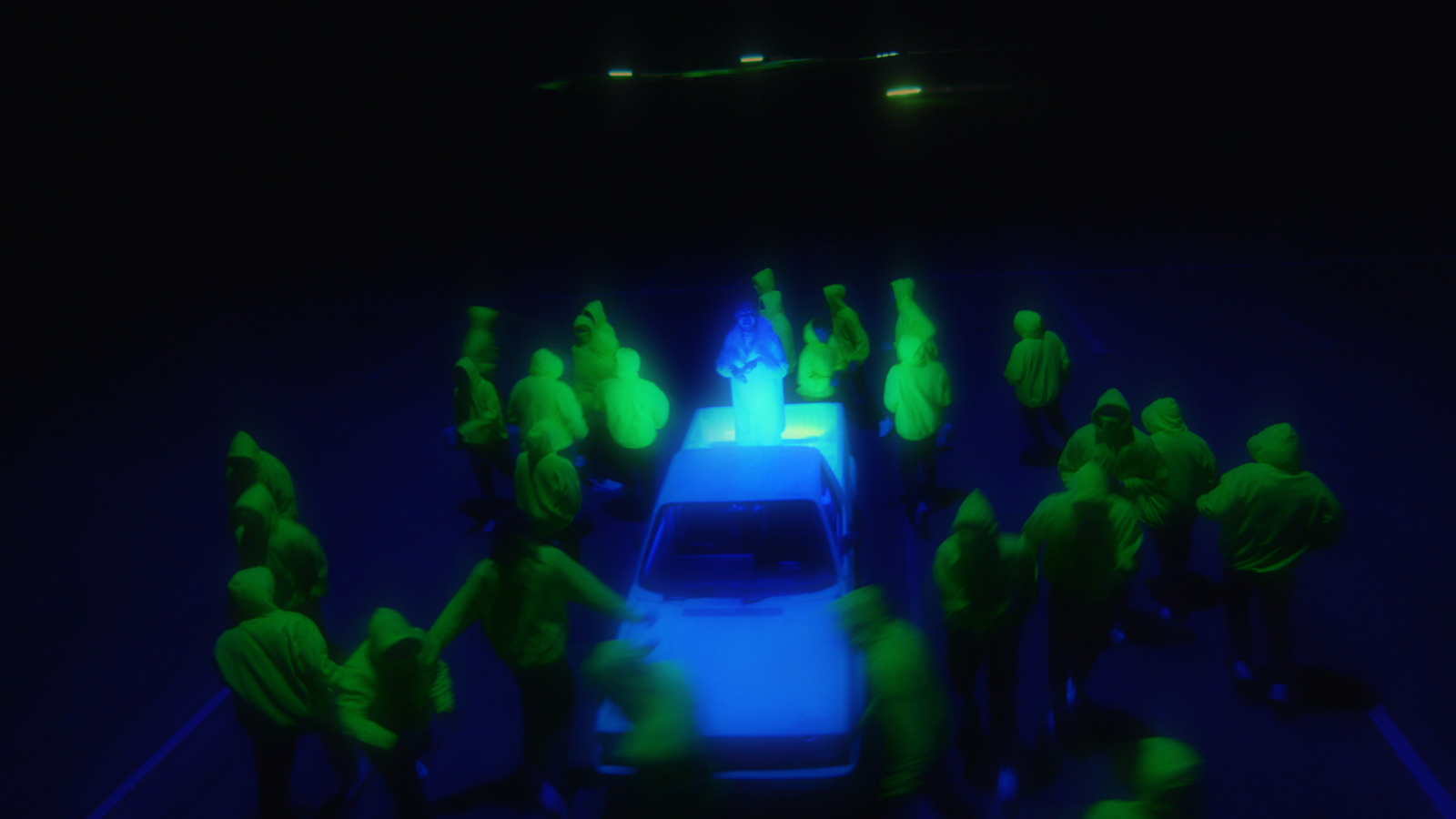 a group of people standing around a car in the dark