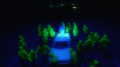 a group of people standing around a car in the dark