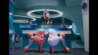 a woman sitting on top of a counter next to two stuffed animals