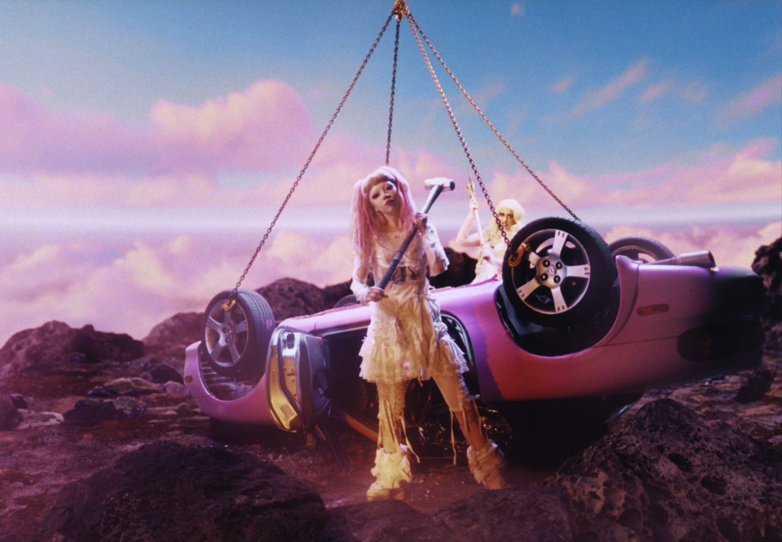 a woman on a car being lifted by a crane