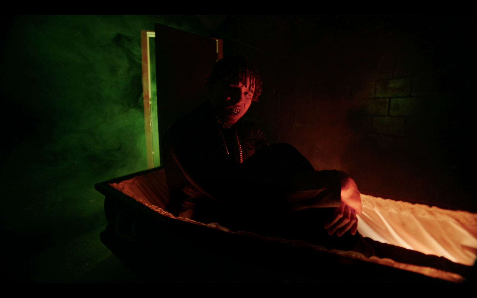 a man sitting in a bathtub in a dark room