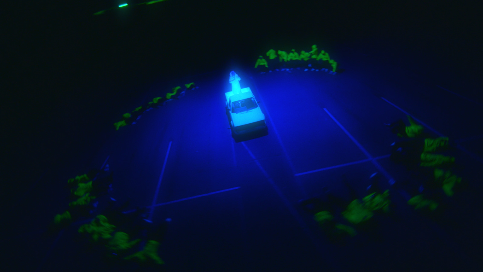 a tennis court lit up in the dark