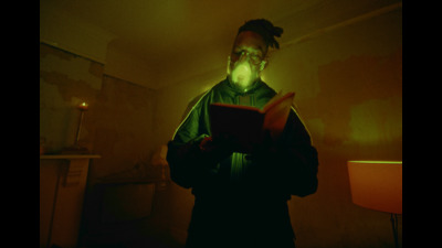 a man in a dark room reading a book