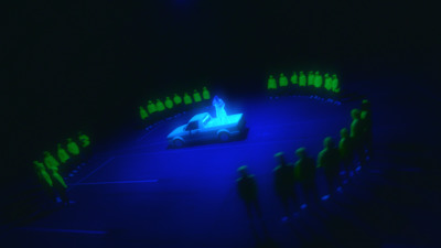 a group of people standing around a car in the dark