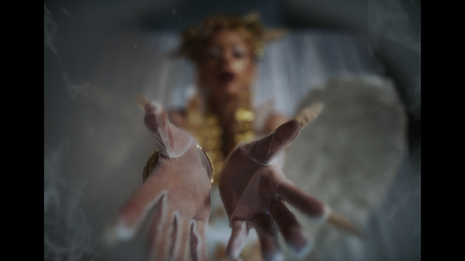 a blurry image of a woman holding her hands out