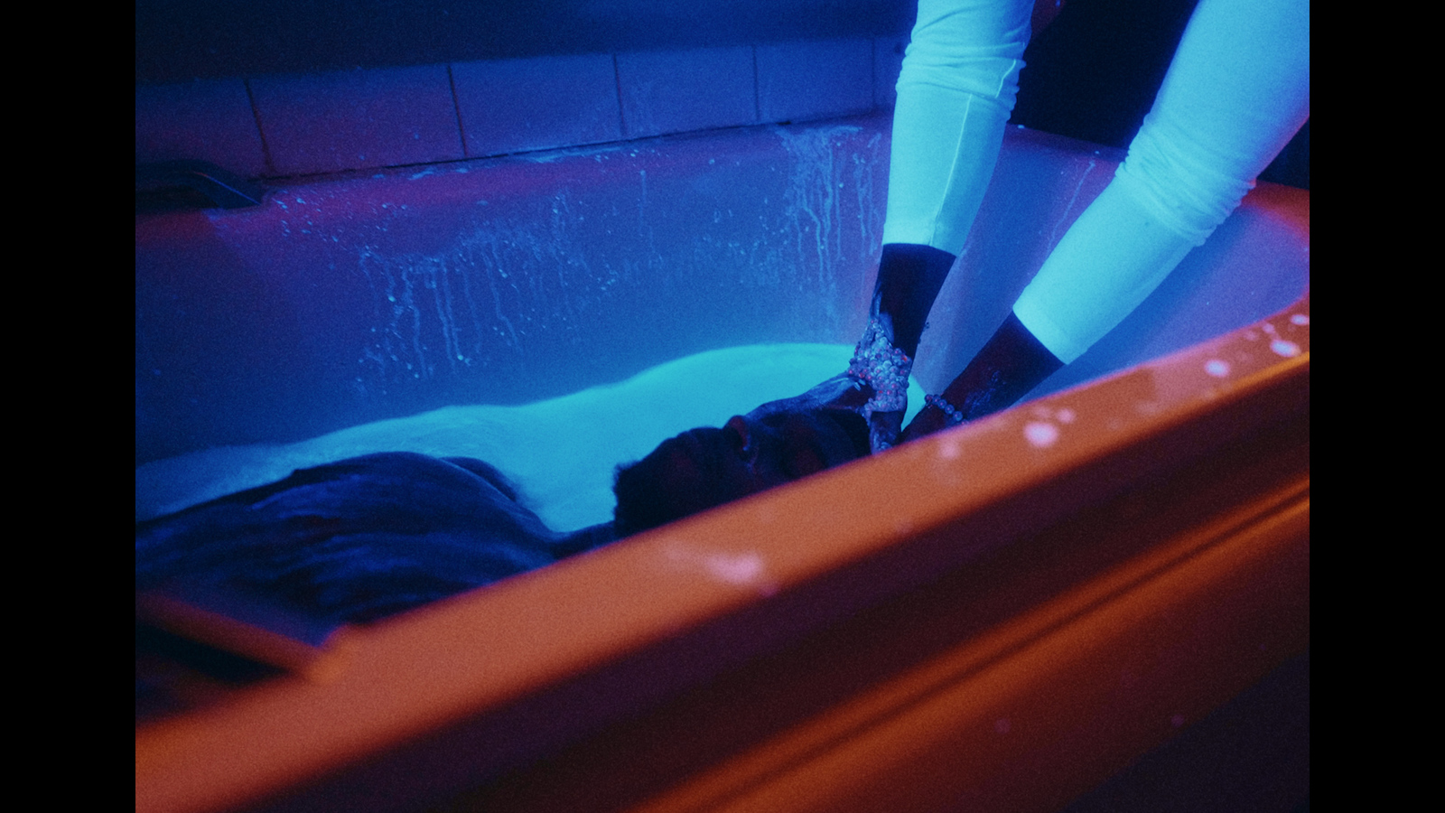 a person in a bath tub with their feet in the water