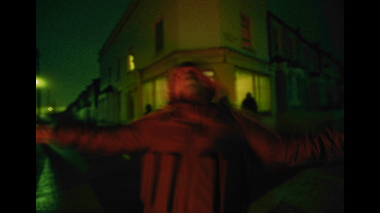 a blurry photo of a man standing in front of a building