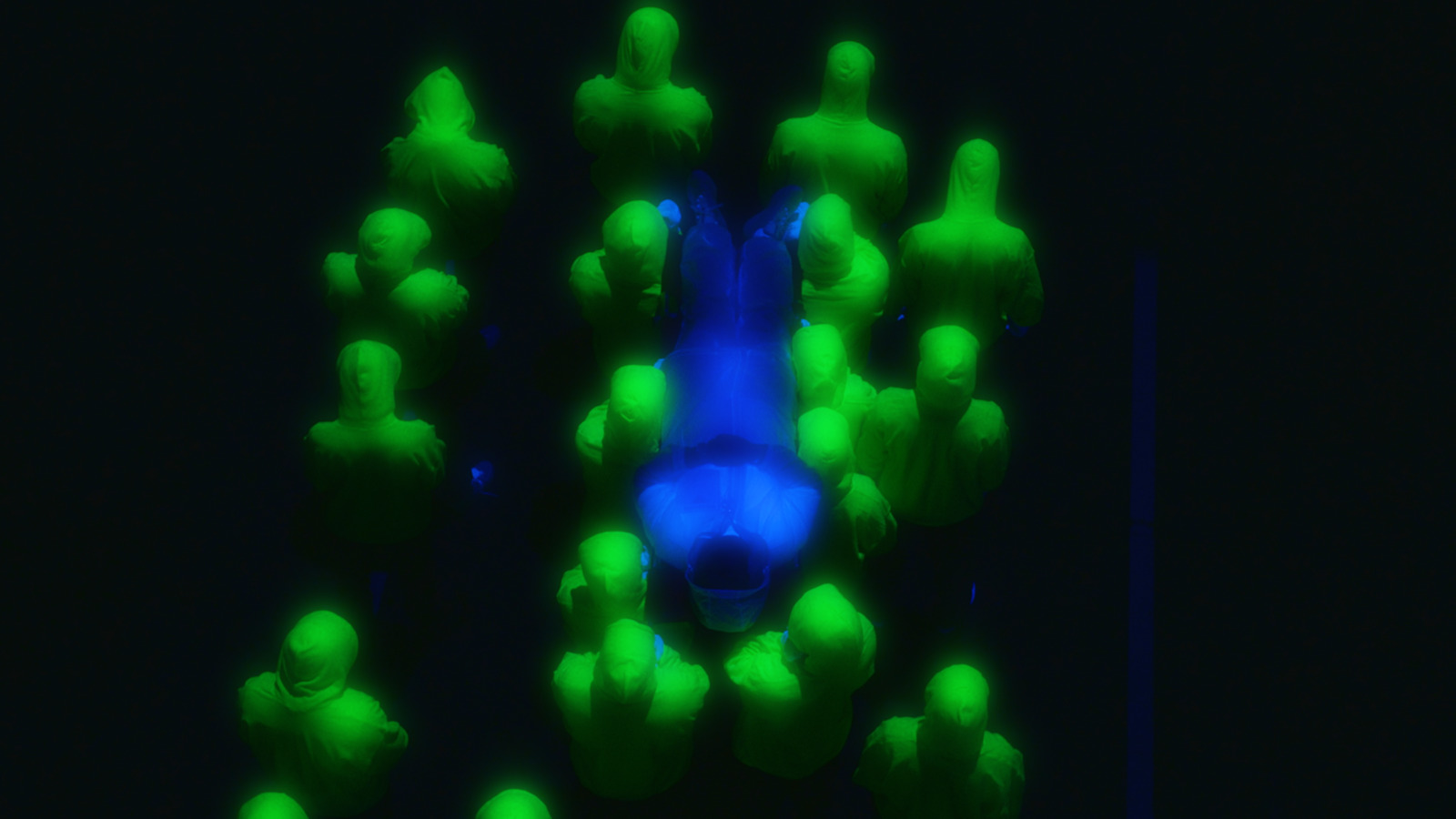 a group of people standing in a dark room