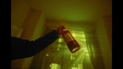 a person holding a bottle in the air