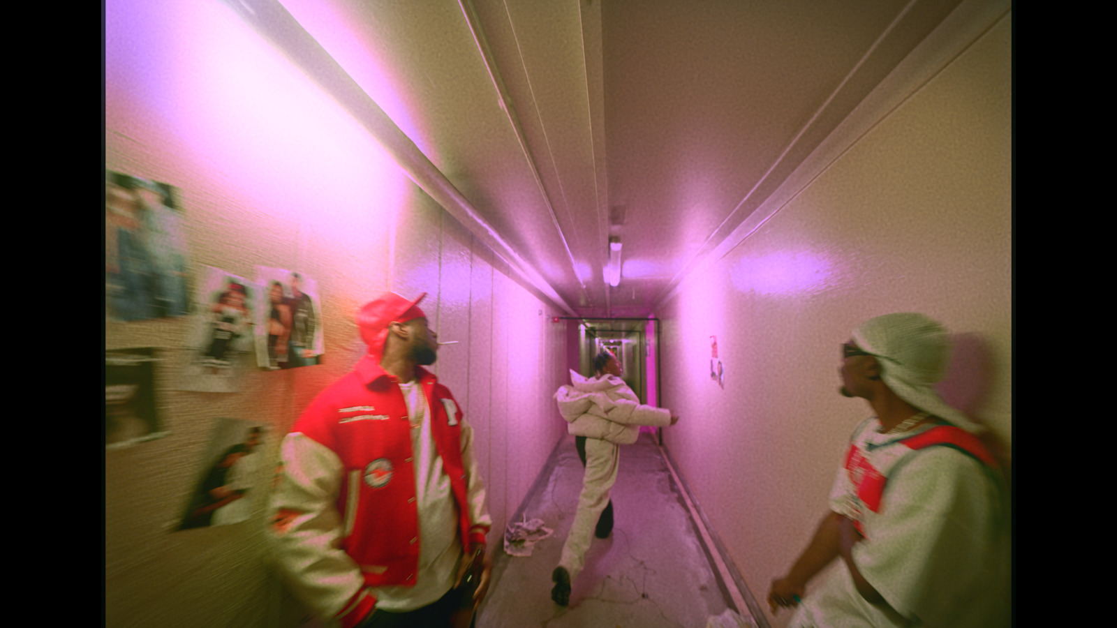 a couple of men walking down a hallway next to each other