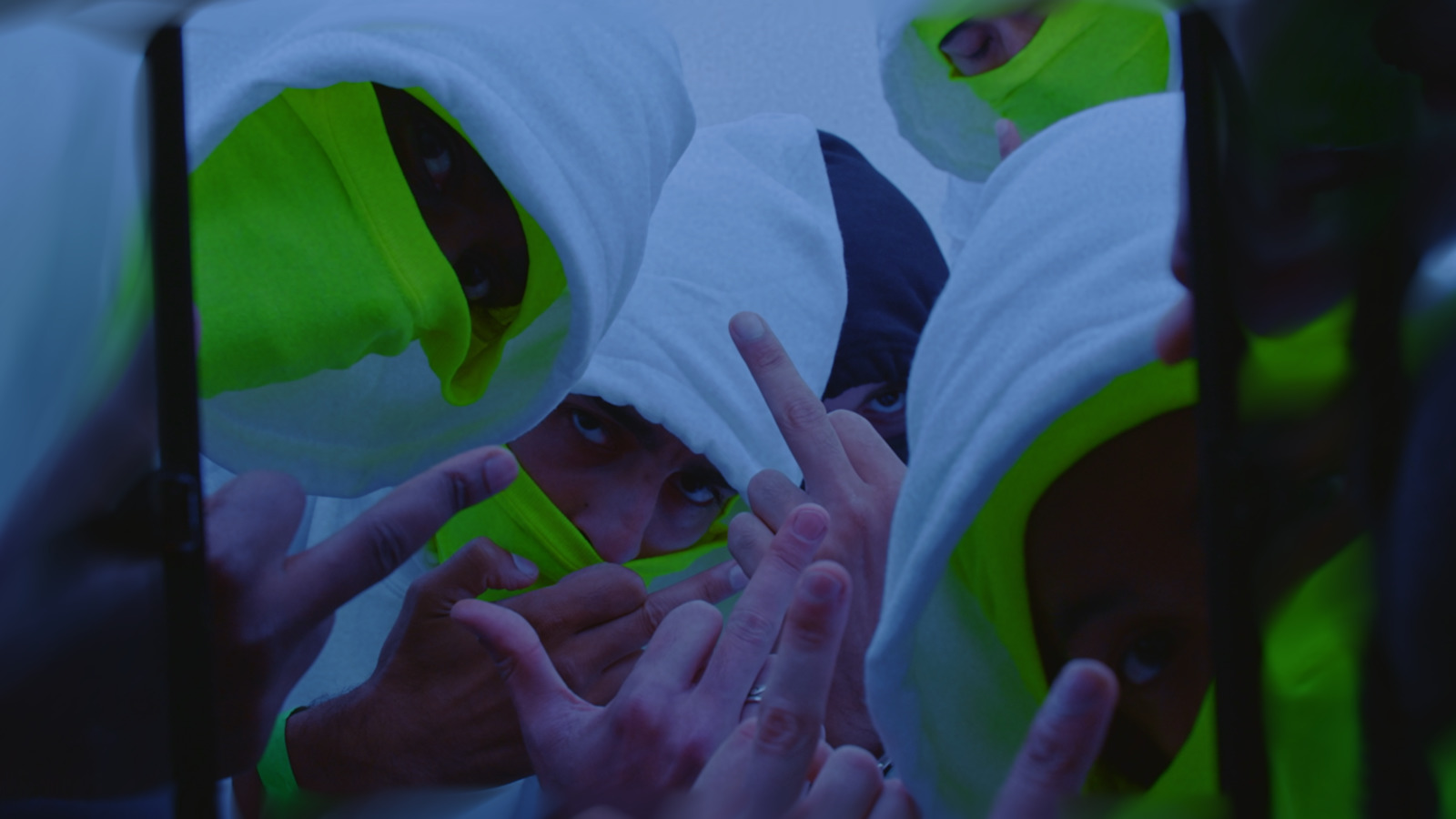 a group of people wearing neon green hoodies