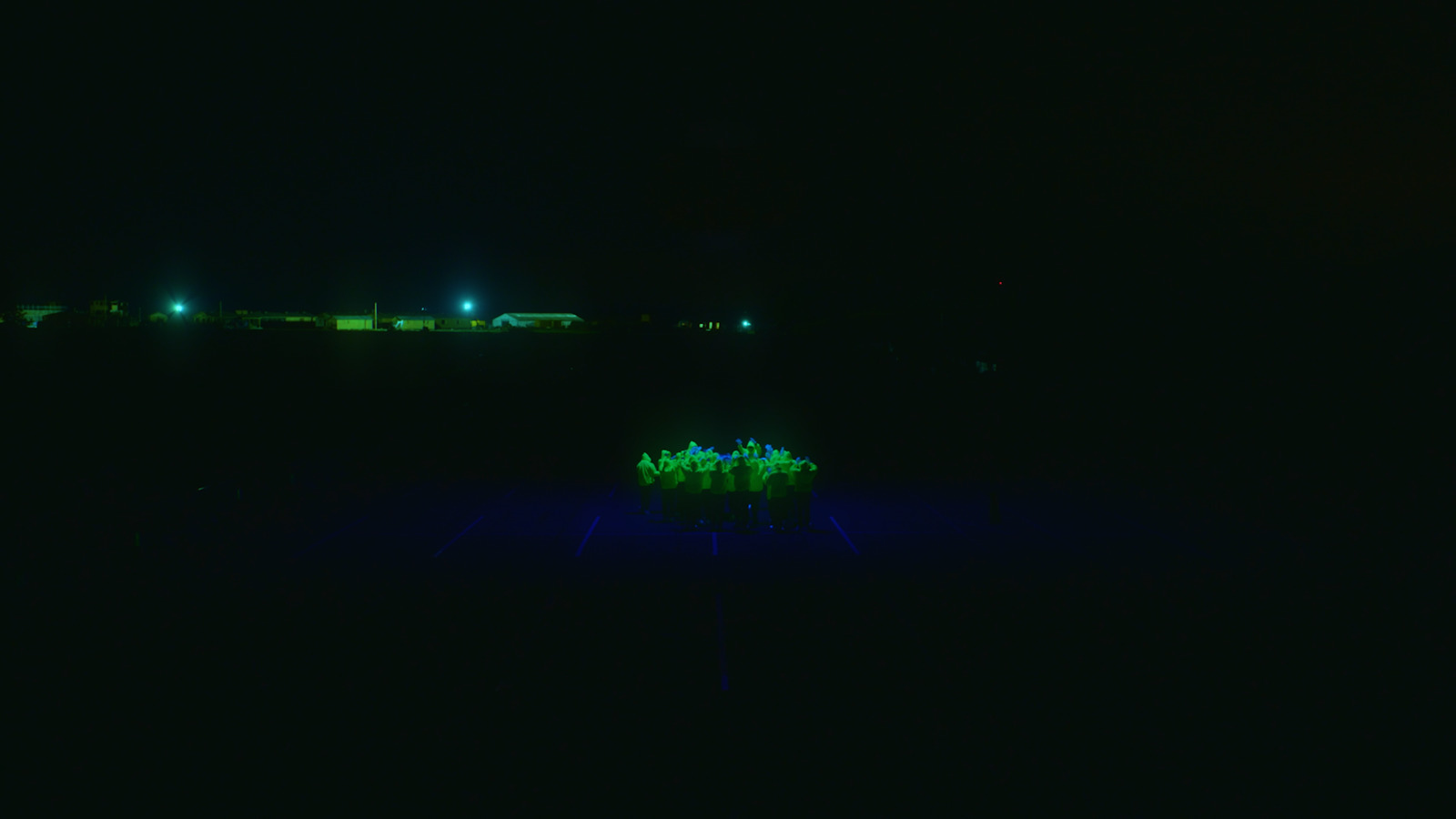 a group of people standing on top of a tennis court