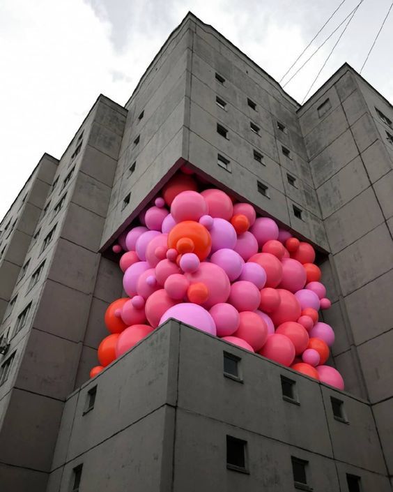 a building with a bunch of balloons on the side of it