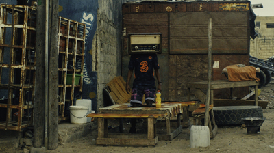 a man standing in the doorway of a shack