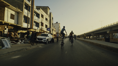 a group of people riding bikes down a street