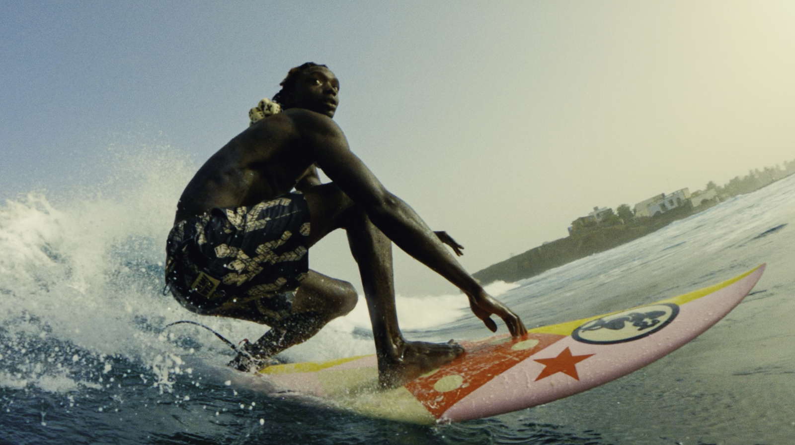 a man riding a surfboard on top of a wave