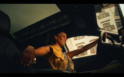 a woman sitting in the driver's seat of a car