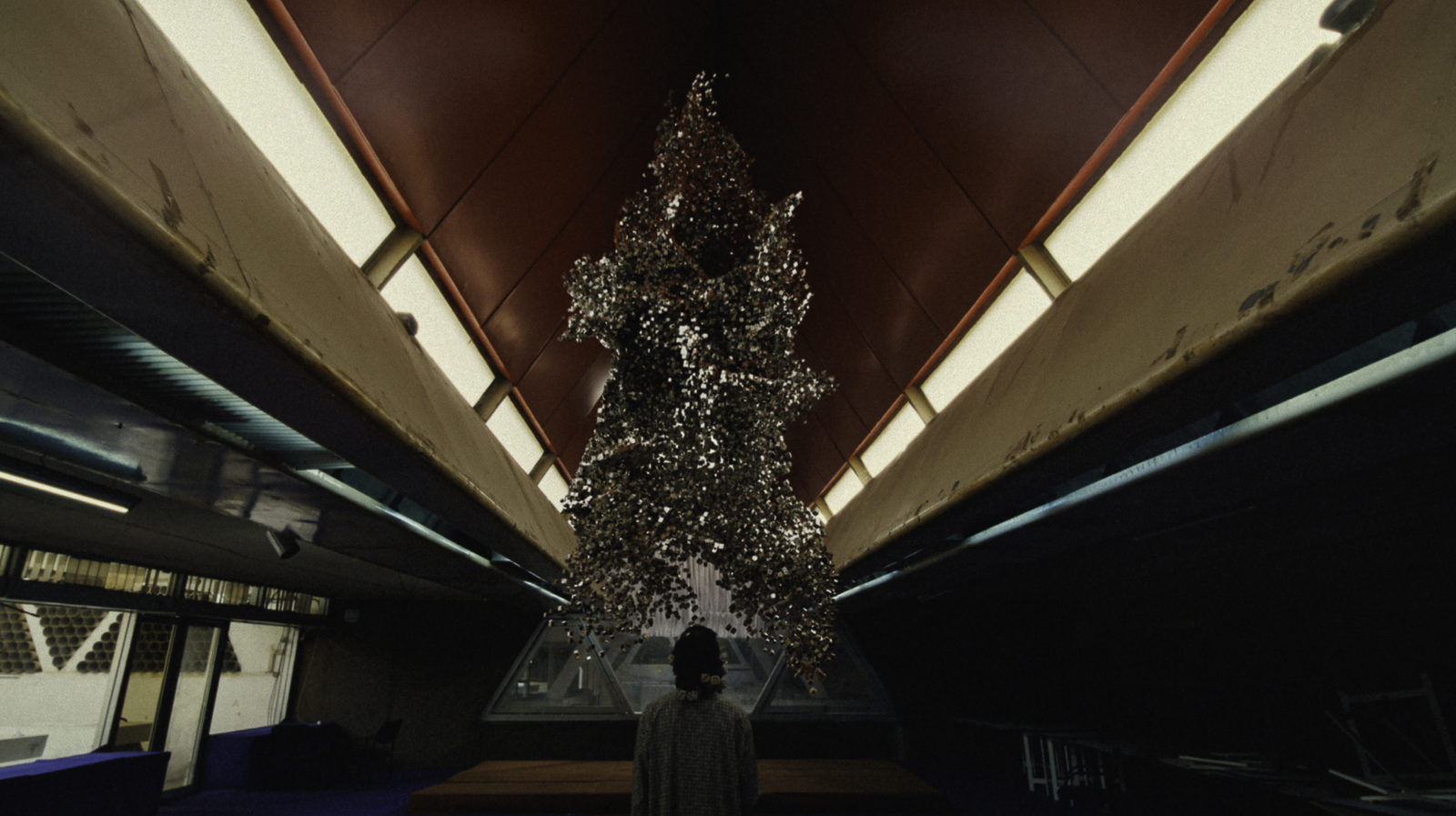 a person standing in front of a christmas tree