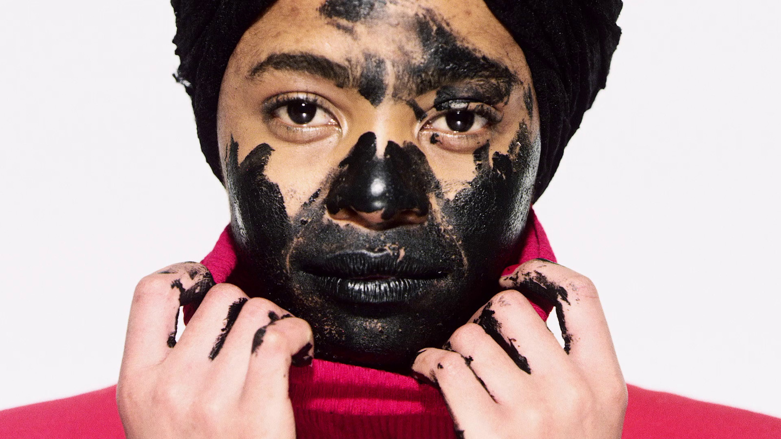 a person with black face paint on their face