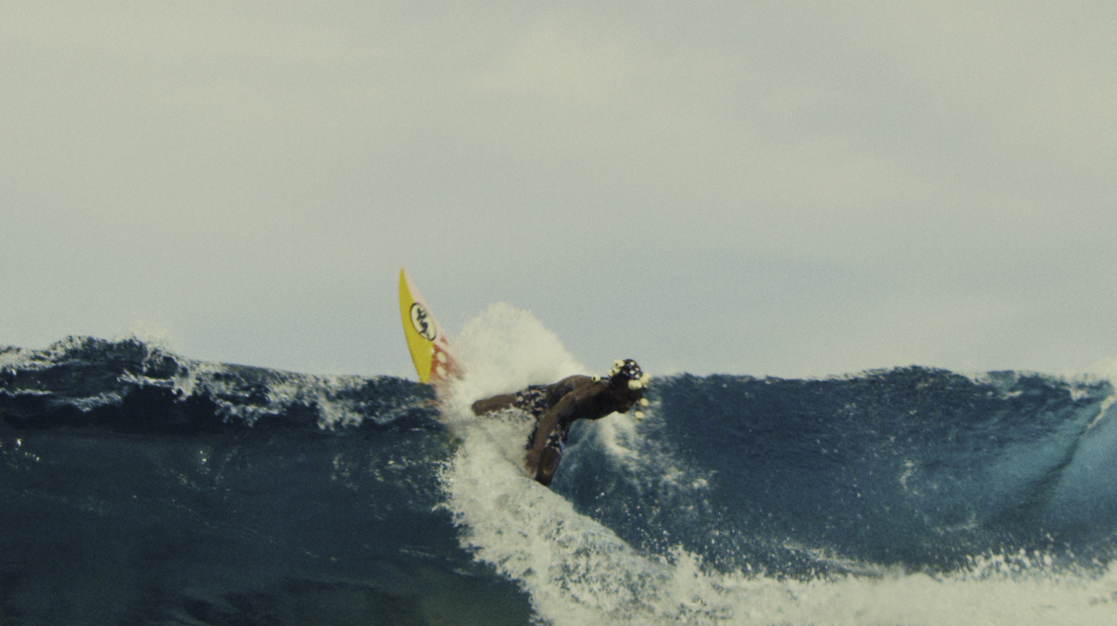 a man riding a wave on top of a surfboard