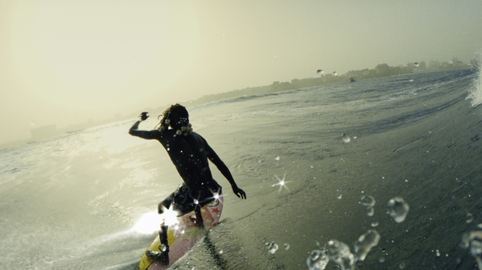 a man riding a wave on top of a surfboard