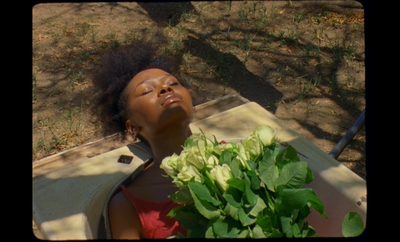 a young girl holding a bunch of green plants