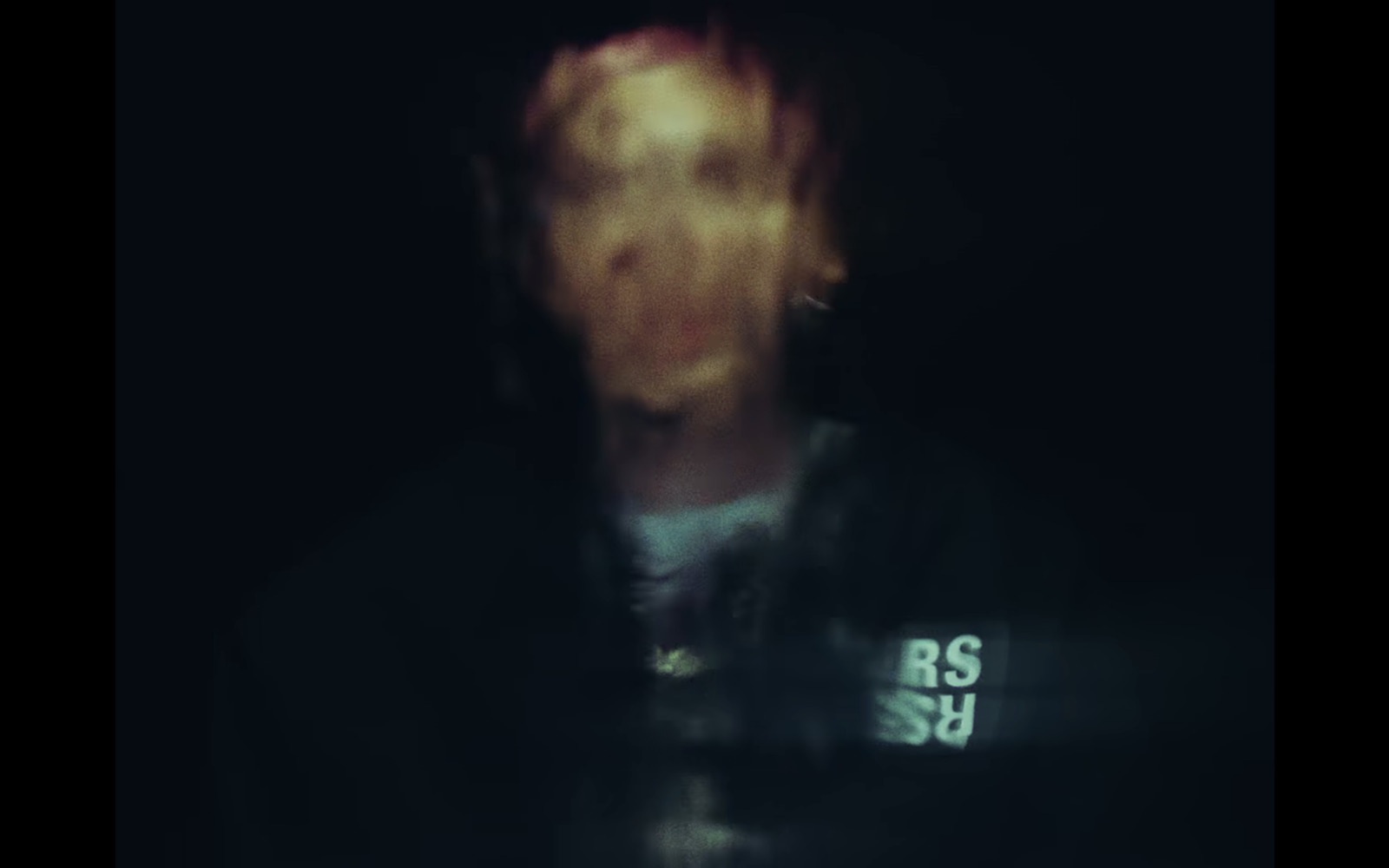 a blurry photo of a person with a cell phone