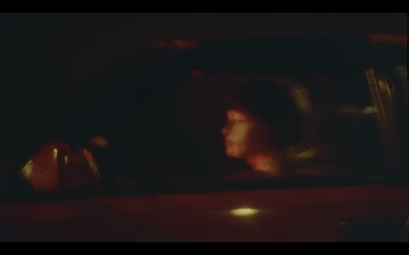 a blurry photo of a woman sitting in a car