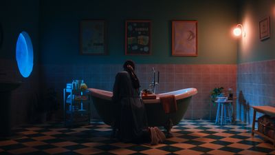 a woman sitting in a bathtub in a bathroom