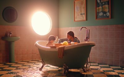 a woman and a child sitting in a bathtub