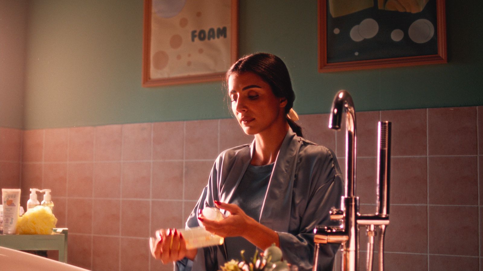 a woman is washing her hands in a bathroom