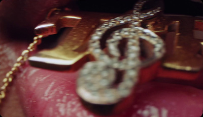 a close up of a gold and diamond necklace