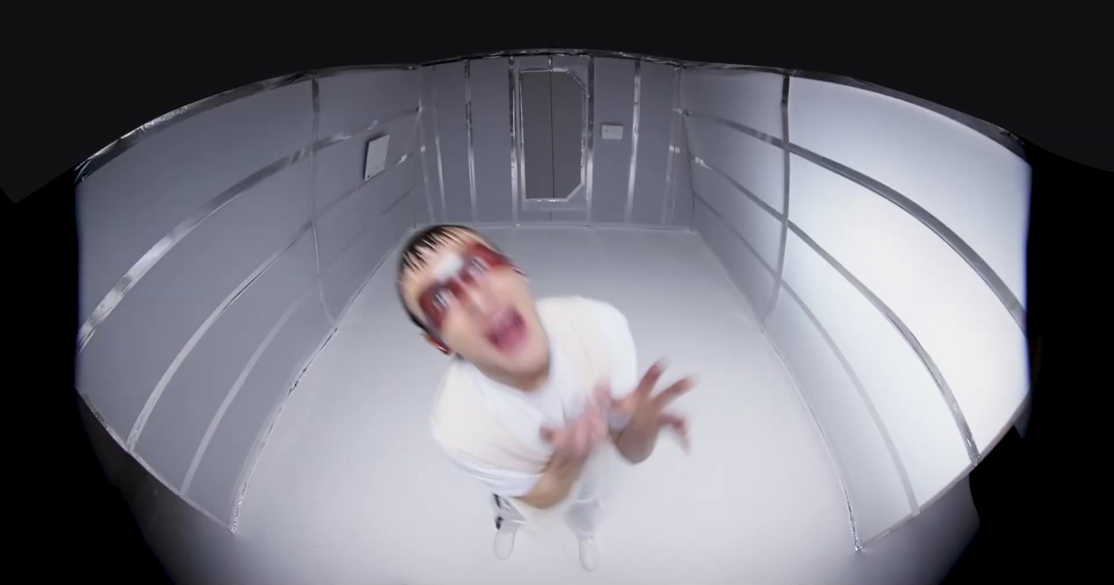 a man in white shirt standing in a room