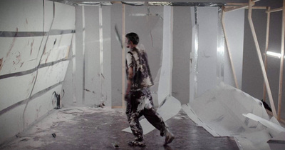 a man standing in a room with white walls