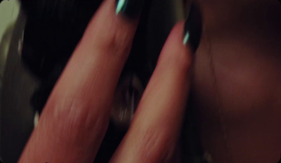 a close up of a person's nails with green nail polish