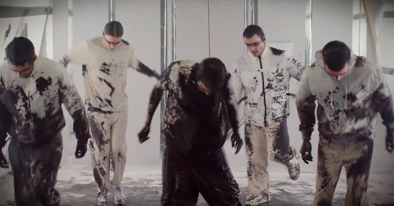 a group of men walking through a dirty room