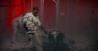 a man in a white suit and a dog in a red room