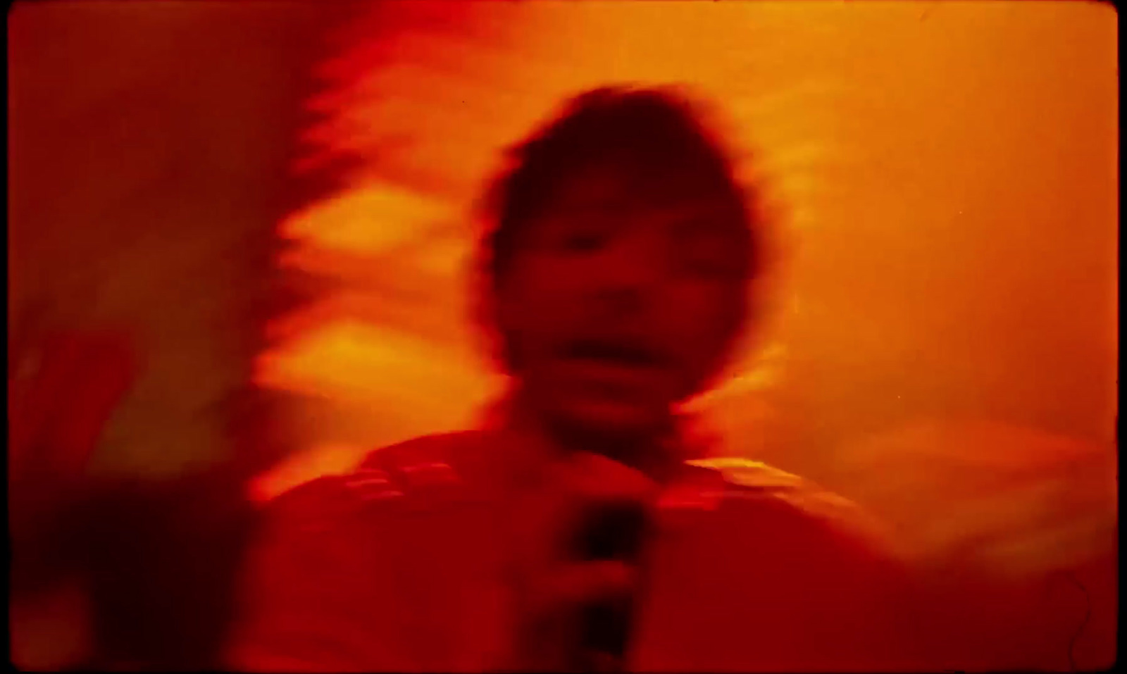 a blurry photo of a man holding a microphone