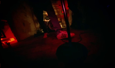 a person sitting in a chair in a dark room