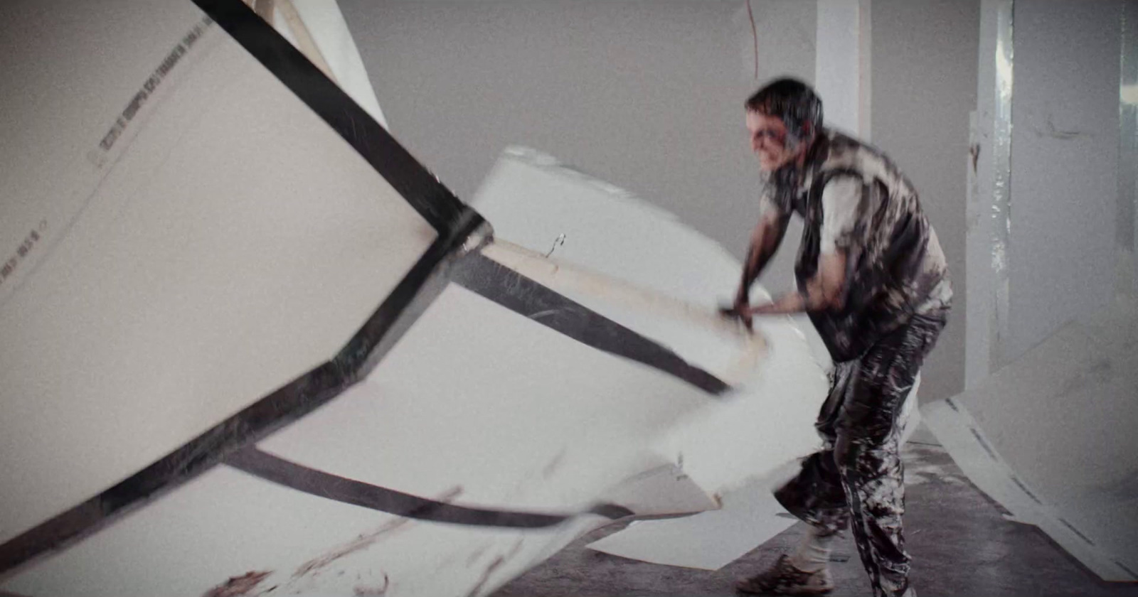 a man standing next to a large white object