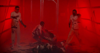 a group of men standing next to each other in a red room