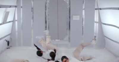 a group of people laying on top of a white floor