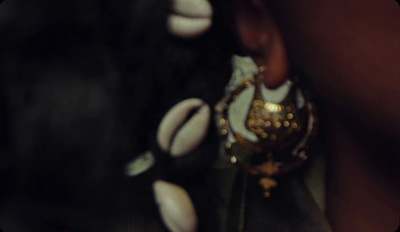 a close up of a person wearing a pair of earrings