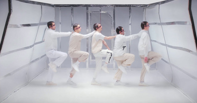 a group of people standing in a white room