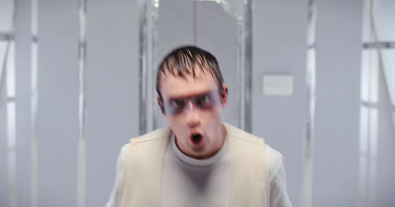 a man making a surprised face in a room