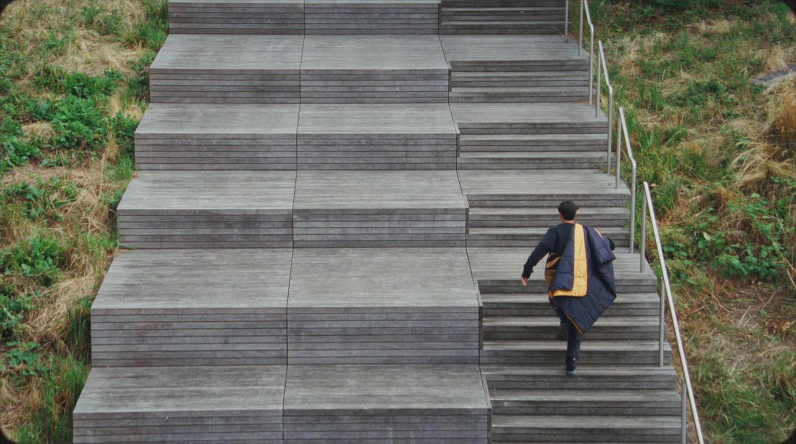 a man in a suit walking up some steps