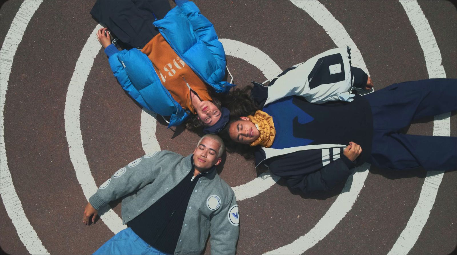 a group of people standing in the middle of a street