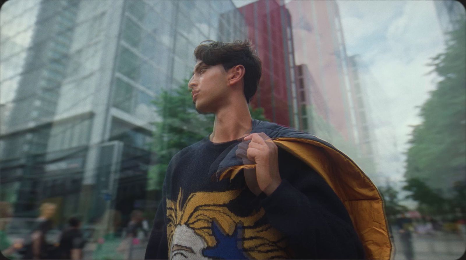 a man with a cape standing in front of a building