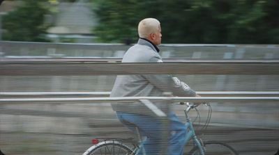 a man riding a bike down a street