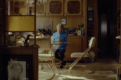 a woman sitting at a table in a room